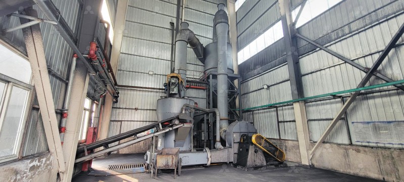 Industrial grinding mill in operation at a mineral processing facility