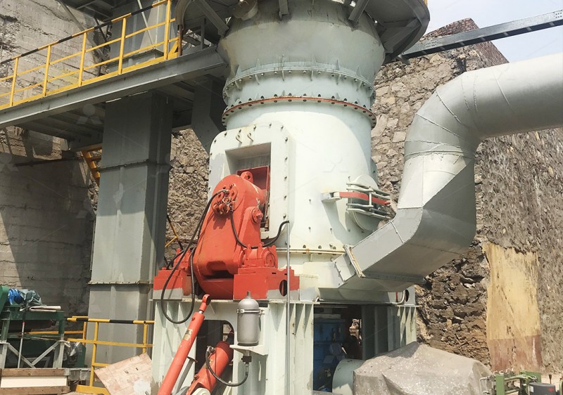 Roller mill processing clay material in industrial setting