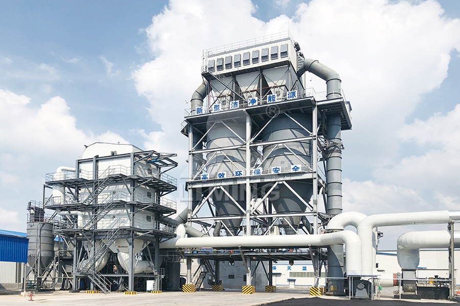 Engineers overseeing the installation of a large vertical grinding mill in an industrial plant.